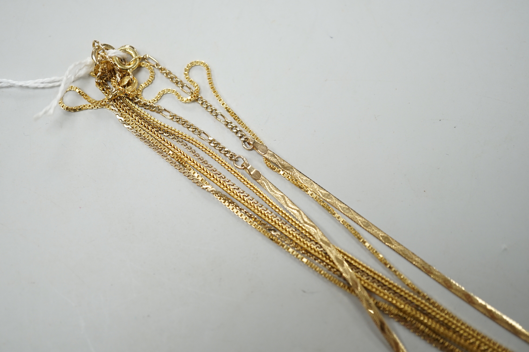 Two modern 9ct gold chains, longest 50cm, 6.3 grams, a 14k chain, 46cm, 2.6 grams and a 750 yellow metal chain, 38cm, 3.5 grams.